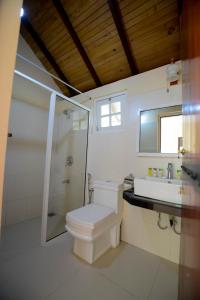 a bathroom with a toilet and a shower and a sink at The Tea Garden in Nuwara Eliya