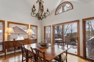 a dining room with a table and chairs and windows at Wycham Place in Boone