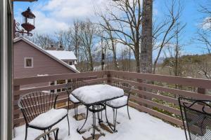 a balcony with snowcovered chairs and tables on a fence at Wycham Place in Boone +26 photos