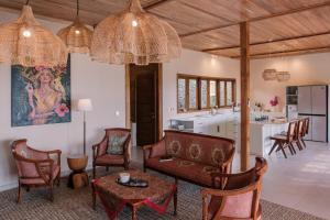 a living room with a couch and a table at Villa Layan Hillside Residency with views and infinity pool in Amed in Ambat