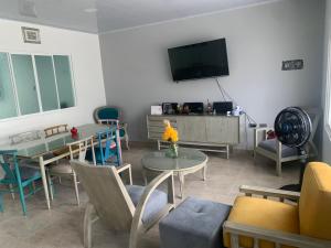 a living room with a tv and a table and chairs at Acacias home in Acacías