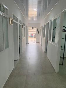 a hallway with white walls and a tile floor at Acacias home in Acacías