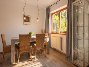 a dining room with a table and chairs and a window at Ferienwohnung Feichten in Westendorf +7 photos