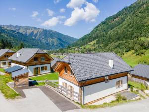 an aerial view of a house with mountains in the background at Im grünen Herzen in Donnersbachwald