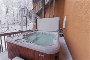 a hot tub with a toilet on a balcony at Pinnacle Ridge Sunrise Sunsets in Beech Mountain