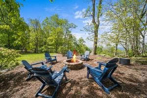 a group of blue chairs around a fire pit at Wolf Ridge Lodge in Boone