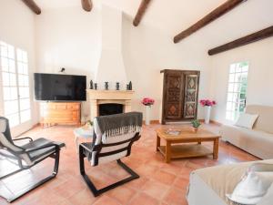 a living room with a couch and a fireplace at Le Rayol in Bagnols-en-Forêt
