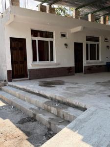 a house with two doors and concrete steps at Vista del Volcán in Santiago Atitlán