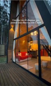 a window of a room with a couch and a table at Chalé Noites Extraordinárias chalesnoitesextraordinarias in Paraíba do Sul