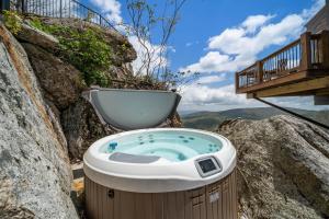 a bath tub sitting on top of a rock at On The Rocks Straight Up in Beech Mountain