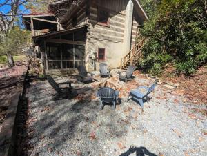 an aerial view of a house with chairs and a table at Creekside Cabin in Blowing Rock