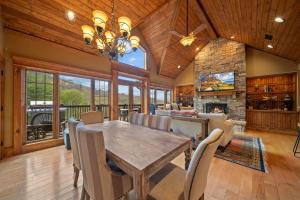 a dining room with a table and a fireplace at Birds Nest On Sugar Mountain in Sugar Mountain