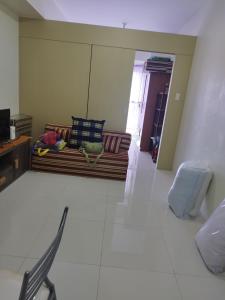 a living room with a couch and a table at Wind Residences in Tagaytay +1 photo