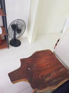 a wooden table in a room with a fan at Wind Residences in Tagaytay