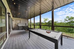 a large screened porch with a pool table on a deck at Luxury Trails Escape in Boone