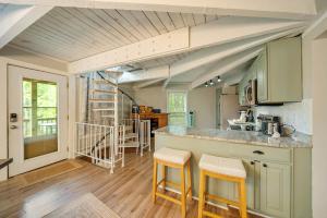 a kitchen with a counter and two stools at Treehouse On Beech in Beech Mountain
