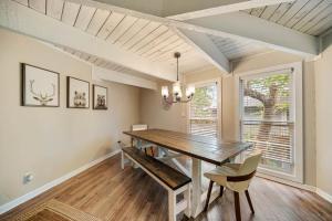 a dining room with a wooden table and a window at Treehouse On Beech in Beech Mountain