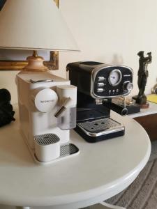 a coffee maker and a toaster on a table at Studio VIP - Bonamoussadi - Groupe électrogène - 2douches in Douala