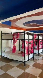 two bunk beds in a room with a blue ceiling at Mekong Backpackers in Pakbeng +53 photos