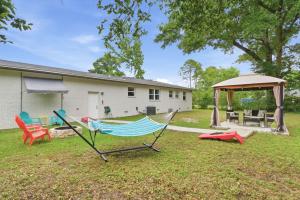 a yard with chairs and a gazebo at Escape by Beaches & Blue Angels in Pensacola