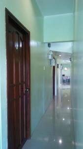 an empty hallway with a door and a room at Dweller's Pensione in Iloilo City