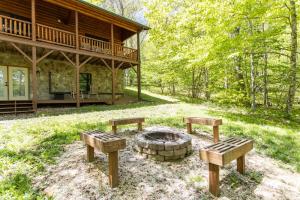 a fire pit in front of a log cabin at A Beary Good Time in Boone