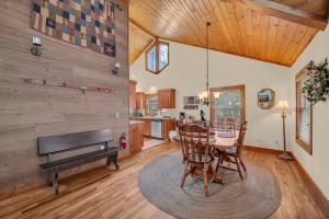 a living room with a table and a piano at Appalachian Breeze in Blowing Rock