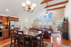 a kitchen and dining room with a wooden table and chairs at Appalachian Ski Mountain Chalet in Blowing Rock