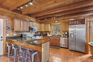 a kitchen with wooden cabinets and a stainless steel refrigerator at A-Typical in Boone