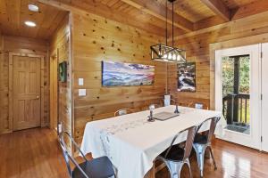a dining room with a white table and chairs at A-Typical in Boone