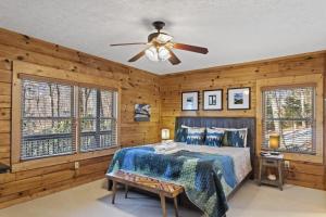 a bedroom with a bed and a ceiling fan at A-Typical in Boone