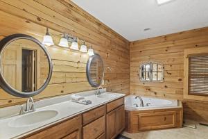 a bathroom with two sinks and two mirrors at A-Typical in Boone +25 photos