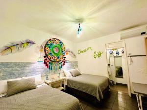 a room with two beds and a mirror on the wall at Hotel y Arte Antigua by Amazing Guatemala Travel in Antigua Guatemala