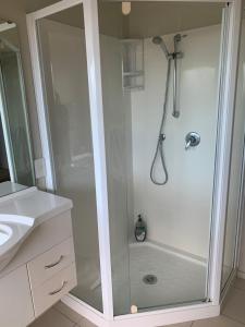 a shower with a glass door in a bathroom at Private Retreat in Cambridge