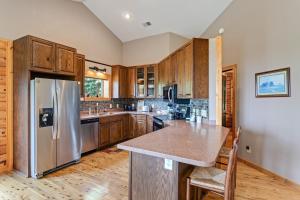 a kitchen with a stainless steel refrigerator and wooden cabinets at Blue Mist in Blowing Rock