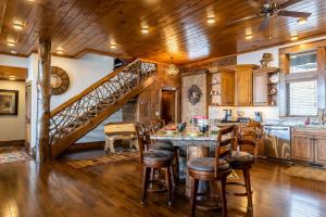a kitchen with a table and chairs and a staircase at Cardinal Perch in Beech Mountain +39 photos