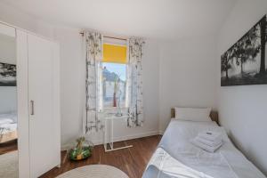 a bedroom with a bed and a window at Marina Hafenblick 321 in Cuxhaven