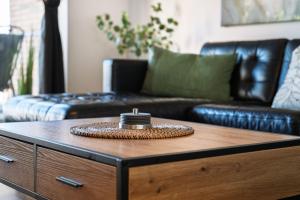 a living room with a couch and a coffee table at Marina Hafenblick 321 in Cuxhaven +4 photos