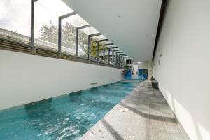 an empty swimming pool in a building with windows at The Port Melbourne Experience in Melbourne