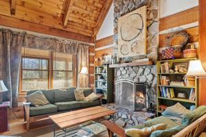 a living room with a couch and a fireplace at Trailhead Cabin in Boone