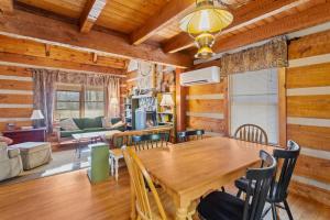 a dining room and living room with a wooden table at Trailhead Cabin in Boone