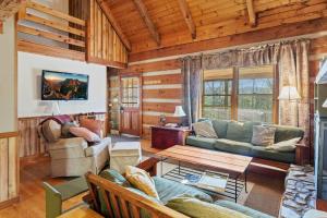 a living room with a couch and a table at Trailhead Cabin in Boone