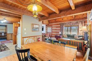 a dining room and living room with a table and chairs at Trailhead Cabin in Boone