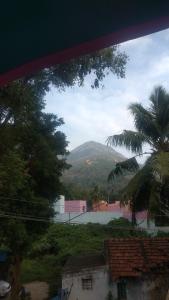 a view of a mountain from a house at Vijaya Guest House in Tiruvannāmalai