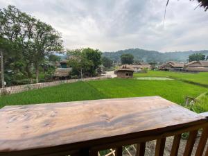 a table on a porch with a view of a yard at Corn family homestay in Làng Me