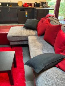 a couch with red and black pillows in a room at MOWA Art House Apartment in Huonville