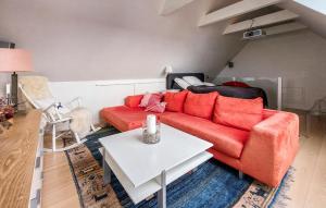 a living room with a red couch and a table at Gorgeous Apartment In Helsingborg With Wifi in Helsingborg