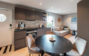 a kitchen and living room with a table and chairs at Gorgeous Apartment In Helsingborg With Wifi in Helsingborg