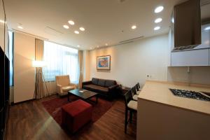a living room filled with furniture and a tv at Orakai Insadong Suites in Seoul