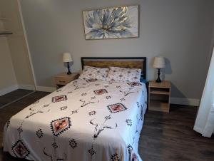 a bedroom with a bed and two night stands with lamps at Entire One Bedroom Condo with AC, Wifi, & Pool in San Antonio